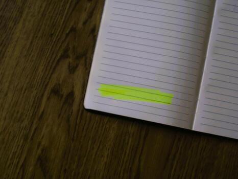 A notebook with a yellow sticky note on it photo