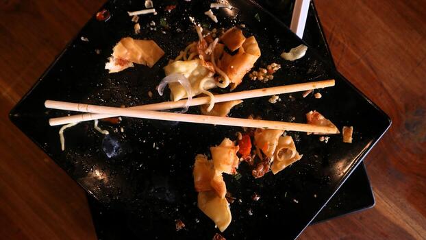 A plate with two chopsticks on it photo