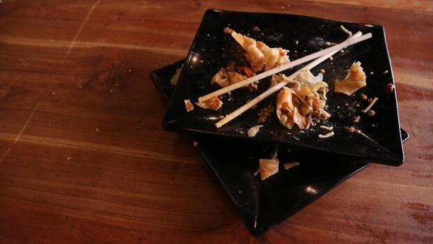 A table with two black square plates on it photo