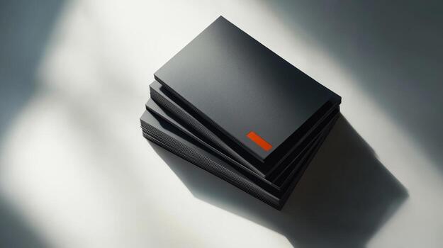 Modern business card design featuring sleek black cards stacked on a light surface photo