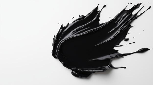 Black paint splatter on a white surface creating an abstract art effect showcasing motion and texture photo