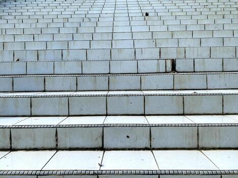 Ascending tiled steps create a repetitive pattern leading upwards towards an unseen destination. photo