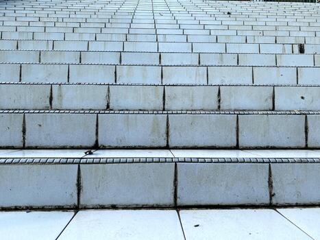 Ascending weathered steps create a textured pattern leading upwards to an unknown destination. photo