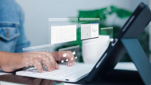 Person using tablet with keyboard and virtual screens of data, calendar, and files symbolizing productivity, digital organization, and remote work photo