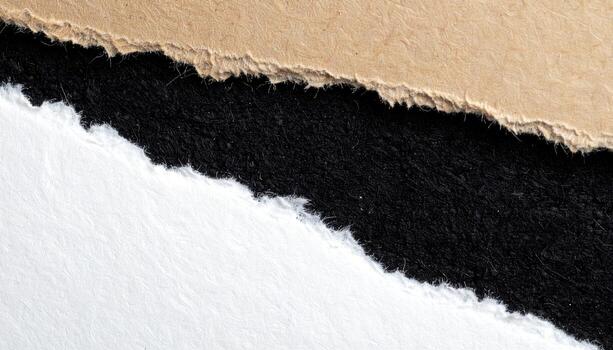 A close-up view of torn pieces of craft paper, cardboard, and dark fabric, creating a textured backdrop with contrasting colors and textures. photo