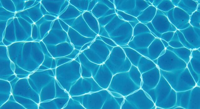 Abstract pattern of light reflecting on a blue swimming pool surface photo
