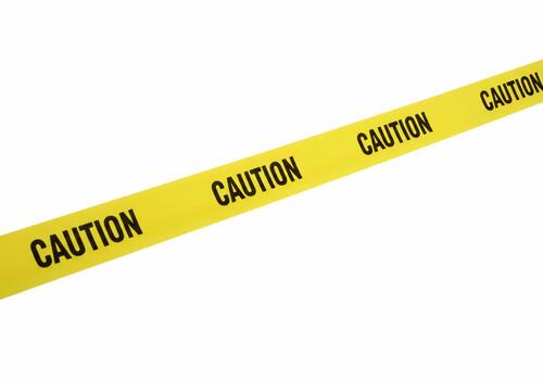 Diagonal Yellow Caution Tape Isolated on White Background photo