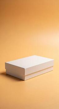 A simple white closed box on a plain orange background photo