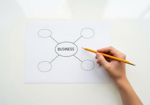 Hand writing business strategy on paper with pencil isolated on white background photo