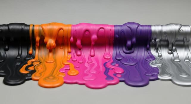 Melted colorful paint drips in a row on a neutral surface photo