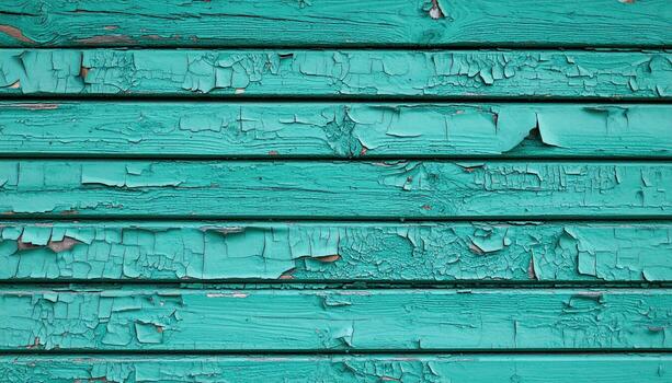 Peeling turquoise paint on wooden planks creates textured, weathered surface with cracks and chips, evoking rustic and aged appearance full of character and history photo