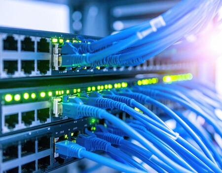 Network switch with multiple blue ethernet cables connected, glowing green indicator lights showing active data transmission in modern server room environment photo