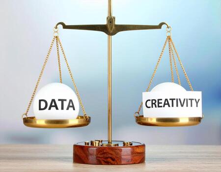 Data and creativity balance concept with golden scale on wooden table, symbolizing equal importance and harmony, inspiring thoughtful decision making and innovation photo