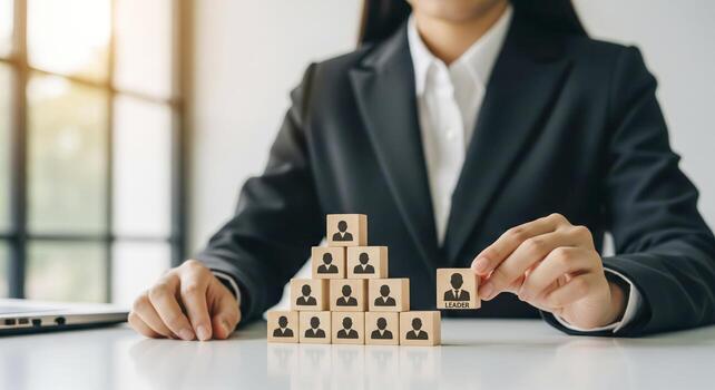 Businesswoman Assembling Leadership Hierarchy With Blocks photo