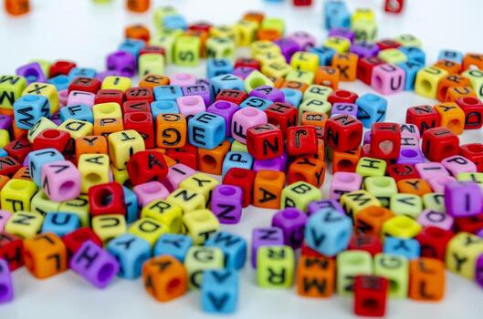 A dense arrangement of colorful transparent alphabet blocks forming a vibrant pattern symbolizing communication and imagination in playful learning photo