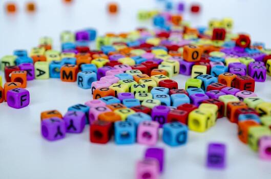 A clustered pile of lively colored alphabet cubes stacked together randomly with clear visibility of different letters representing diversity in communication photo