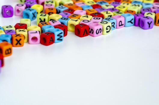 A zoomed in arrangement of bright multicolored cubes with letters scattered randomly symbolizing creativity, word building, and educational playfulness photo