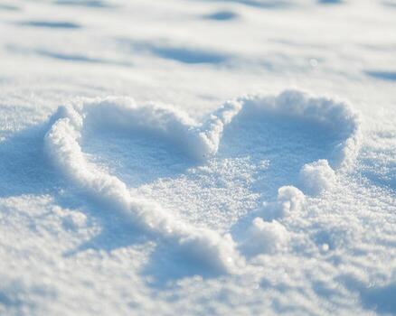 Heart shape drawn in snow on a bright winter day, white isolated background. photo