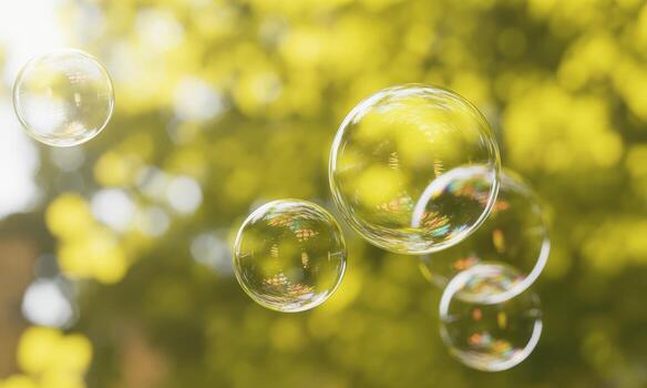 Abstract air bubbles floating against a sunny yellow green nature bokeh background photo