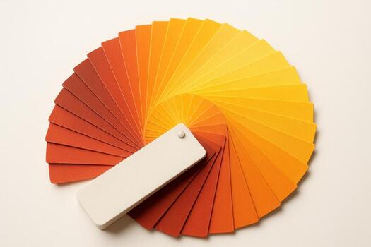 Professional fanned out color swatch book displaying warm tones of red, orange, and yellow photo