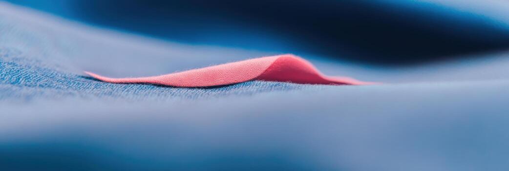 Textile close-up showing delicate folds of pink and blue fabric captured in soft light photo
