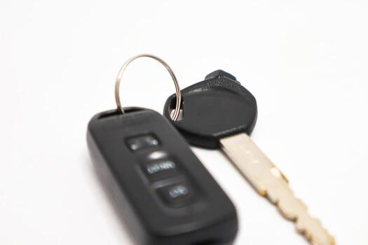 Modern car key with remote on a white background, representing vehicle security and access photo
