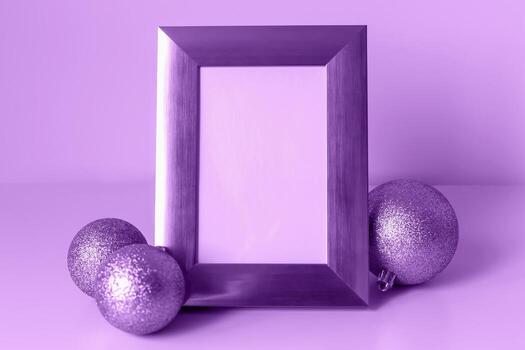 Mockup. Christmas. Decorative purple frame stands prominently with empty space for customization, surrounded glittering ornaments, creating festive atmosphere ideal for holiday-themed design projects photo