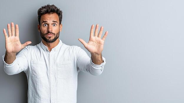 A man is making a stop sign with his hands photo