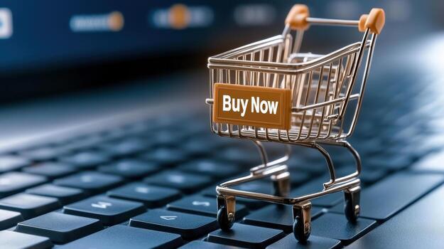 Buy now button on shopping cart on laptop keyboard photo