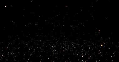 Abstract dynamic falling golden glitter particles and dots. Rain of golden glitter particles on black background. animation of shimmering dust and shiny dots video