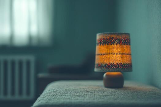 Soft warm light from a lamp illuminates a cozy corner in a quiet room photo