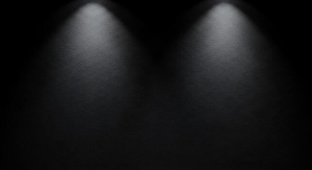 Dark textured wall illuminated by two focused spotlights creating moody lighting effect photo