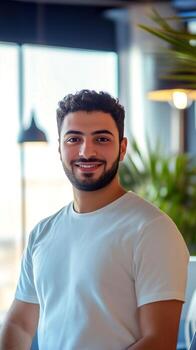 Middle Eastern software developer coding in modern workspace with natural light photo