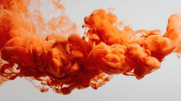 Abstract orange smoke or ink cloud swirling against a clean, light background, creating a dynamic and vibrant visual effect photo