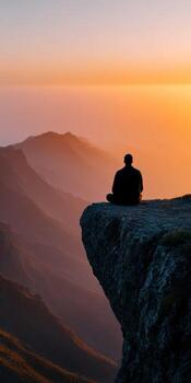 Relaxing meditation at sunset on a mountain edge photo