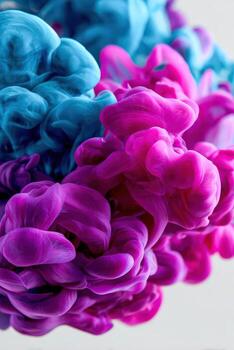 Blue and pink ink clouds forming abstract shapes photo