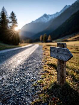 Scenic mountain path with direction sign at sunset in a tranquil valley photo