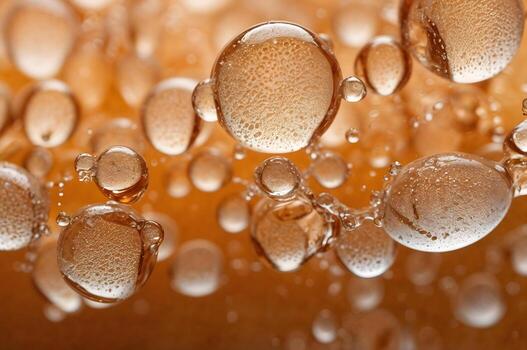 Abstract macro view of golden liquid bubbles and droplets creating a textured, dynamic fluid surface. photo