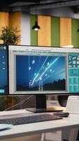 Digital power lines analytics dashboard displays performance data, supporting smart grid optimization. Workstation in office used to analyze sensor data from clean energy generator transmission tower video