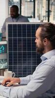 Renewable energy researcher using simulation software to automate solar panels assembly and wind turbines farm infrastructure, improving green industry efficiency, camera A video