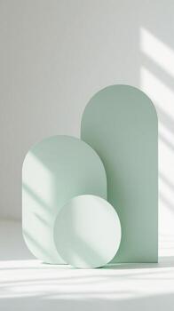 Three green shapes sit on a white surface photo