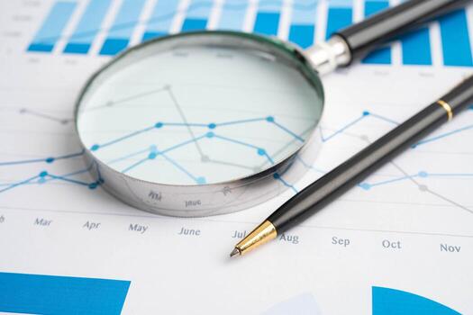 Magnifying glass on data businePuzzle game to play for practice logical thinking.graphs photo