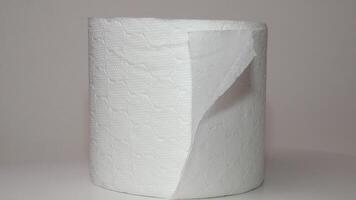 Double-layer toilet paper. Close-up of rotating roll of soft toilet paper on a white background. The concept of hygiene, cleanliness, and care video