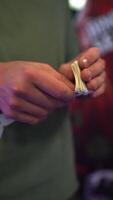 Hands are engaged in the meticulous task of sorting and organizing ticket rolls, highlighting the detailed process and the tactile interaction with the materials in a vibrant setting video