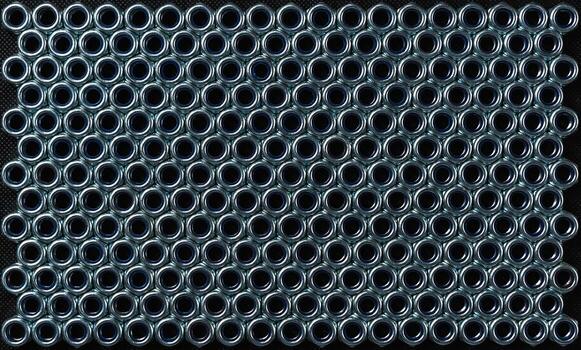 Metal nuts for attaching parts are shown in a seamless pattern for subsequent connections to each other. Texture image for the background photo