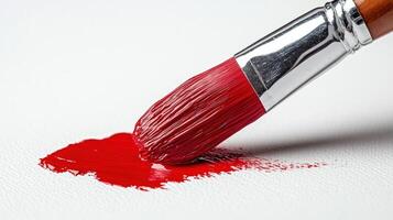 Red paintbrush stroke on white canvas photo