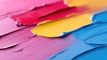 Vibrant paint strokes in hues of pink, yellow, and blue photo