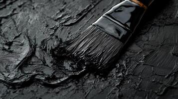 Black Paintbrush on Dark Textured Surface photo