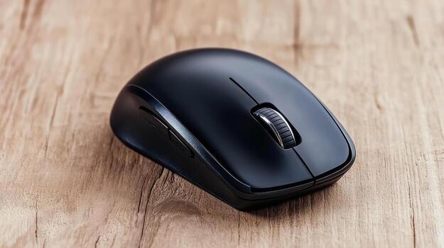 A black wireless mouse on a wooden table photo