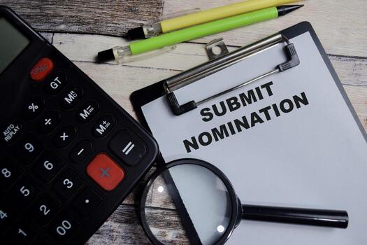 Concept of Submit nomination write on clipboard isolated on Wooden Table. photo